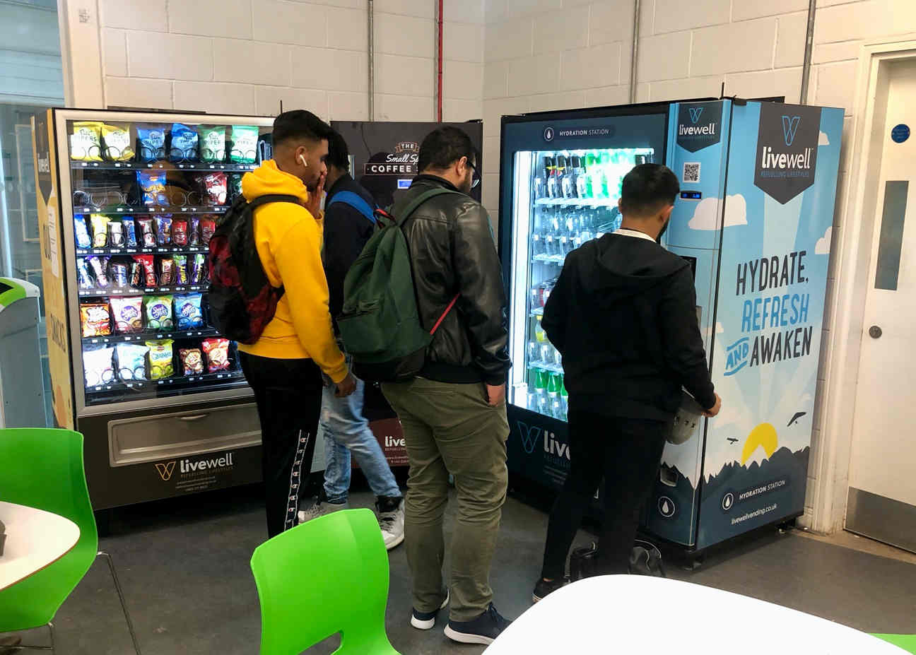 students at bolton college choosing drinks at a vending machine